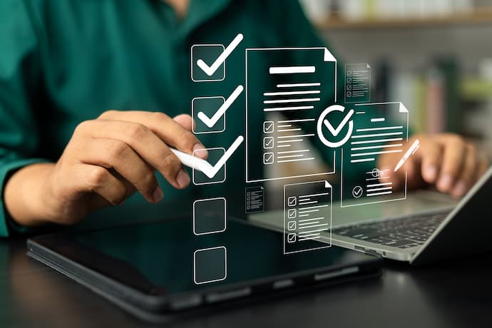 Business man using laptop and tablet online checklist