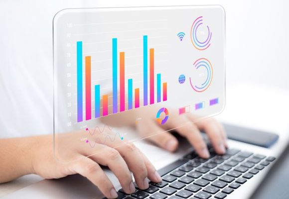 hands typing on a keyboard while a bar chart illustration is shown above