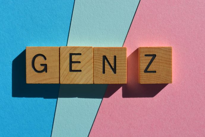 wooden tiles with the letters GEN Z against a colorful blue and pink background 