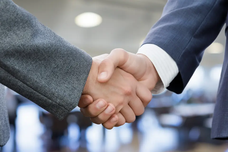 businessmen shaking hands to solidify a deal
